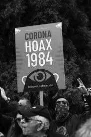 Protest signage referencing pandemic conspiracy theories