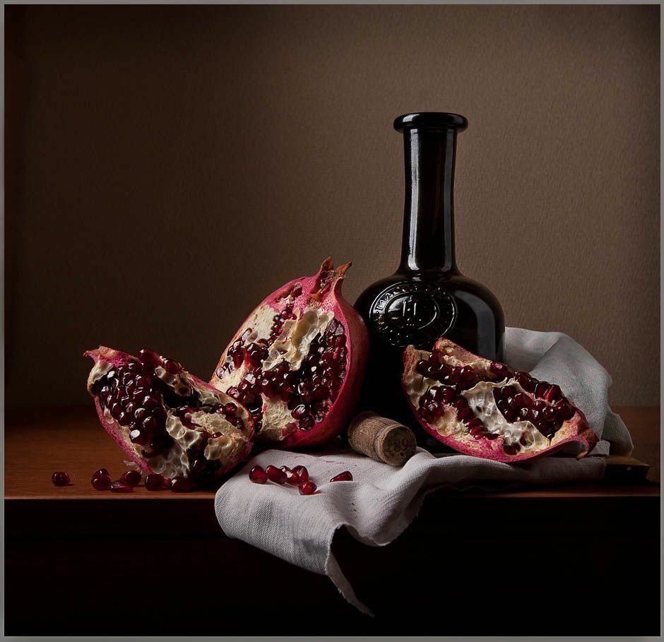 Still life with pomegranate and dark bottle