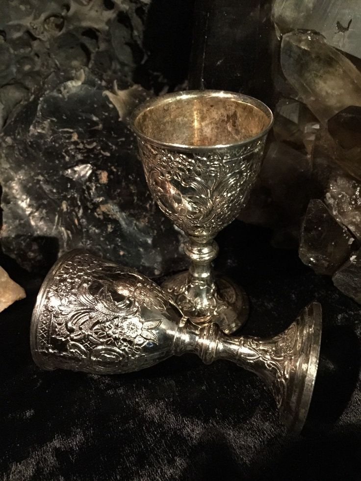 Engraved silver goblets on dark crystal