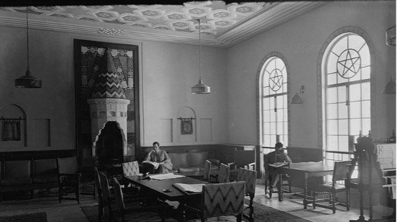 Archival interior photograph with a stained-glass window and star motifs
